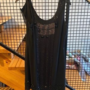 Adorable party dress with pretty bead and sequin accent.